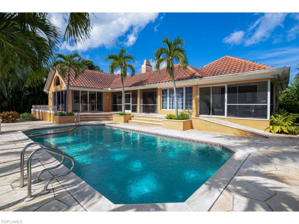 3275 Gin Lane Naples, FL 34102 - Photo 11 of 13 a front view of a house with a yard