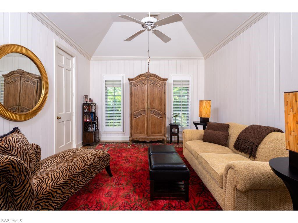 3275 Gin Lane Naples, FL 34102 - Photo 8 of 13 a living room with furniture a mirror and a chandelier
