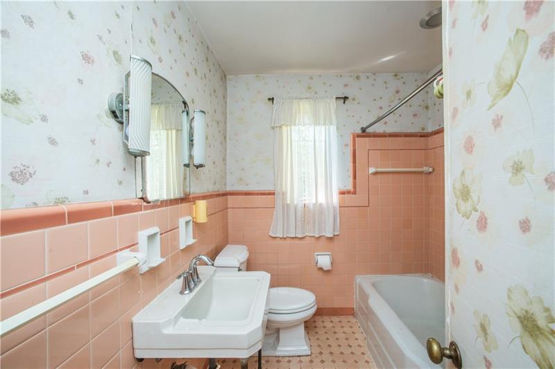 359 Beadling Road Pittsburgh, PA 15228 - Photo 12 of 25 The main bath of the home has an abundance of vintage charm, from the tub/shower combo, to the tiled floor and walls! The pedestal sink with vanity mirror and lighting round out the space nicely.