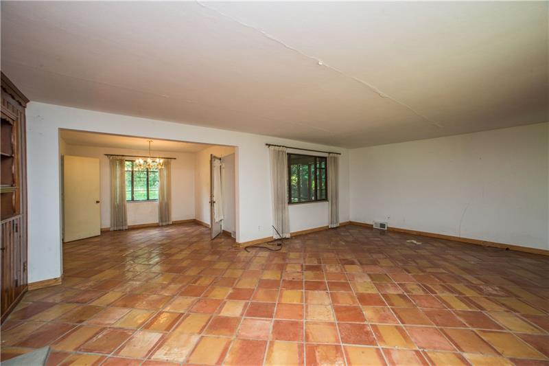 359 Beadling Road Pittsburgh, PA 15228 - Photo 4 of 25 Opposite view from the living area leading to the spacious dining room, the tile flooring continues here. A large window overlooks the back of the property while allowing natural light to flow into the space.