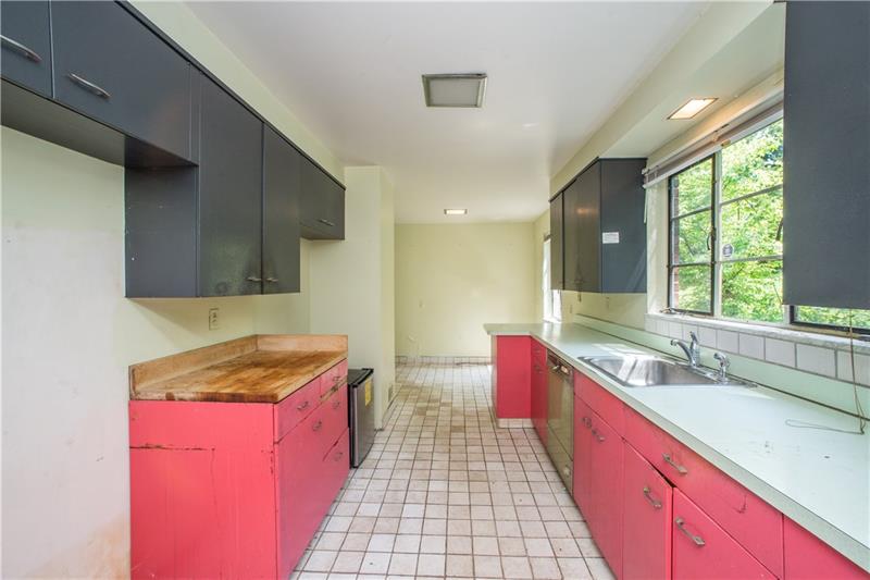 359 Beadling Road Pittsburgh, PA 15228 - Photo 6 of 25 The galley-style kitchen offers loads of counter & cabinet space. The window above the sink floods the room with natural light and overlooks the back yard. Easy-to-maintain tile flooring leads to a cozy eating area at the far end of the kitchen. Just beyond this area (to the left) is access to a first-floor laundry room, and a convenient breezeway leading to the garage.
