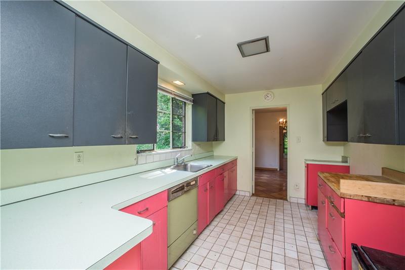 359 Beadling Road Pittsburgh, PA 15228 - Photo 7 of 25 Another view of the kitchen highlights the easy access to the dining room, seen through the doorway at the end.