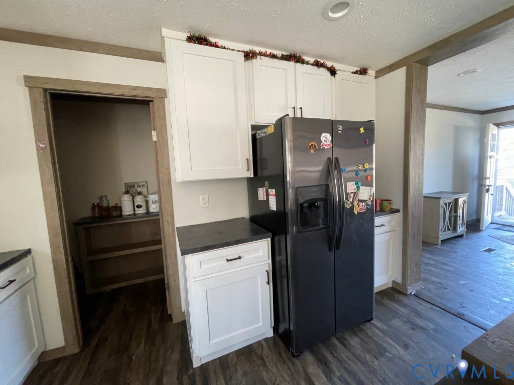 97 Buster Lane West Point, VA 23181 - Photo 13 of 32 a kitchen with a refrigerator and wooden floor