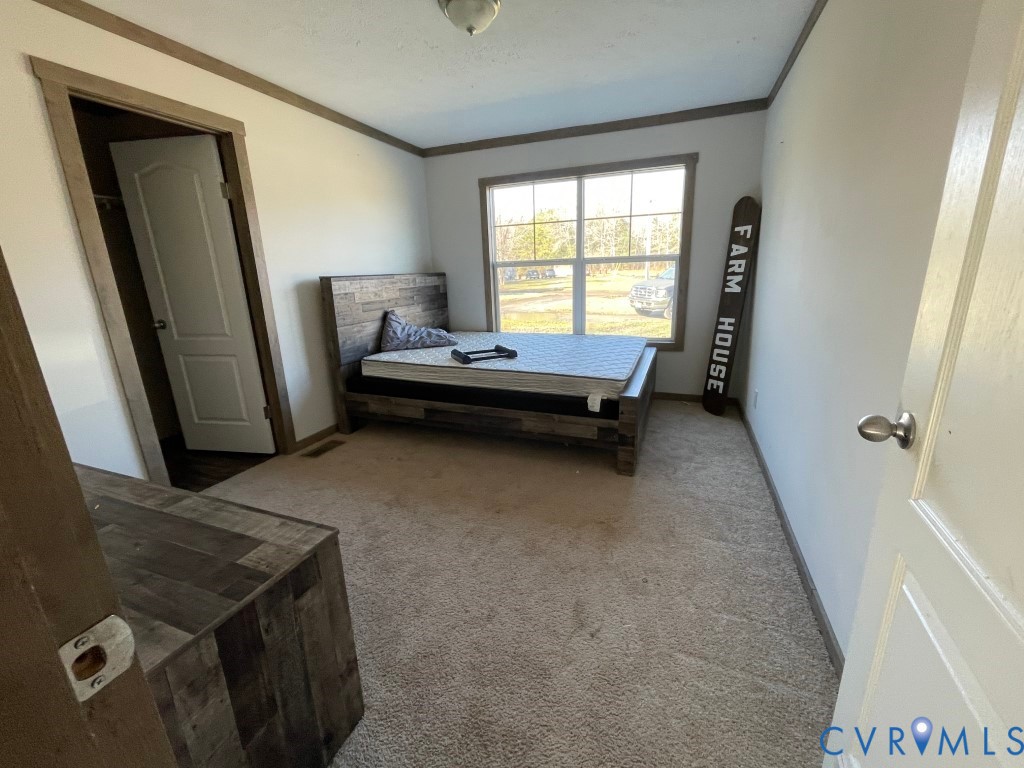 97 Buster Lane West Point, VA 23181 - Photo 15 of 32 a living room with a couch and a window