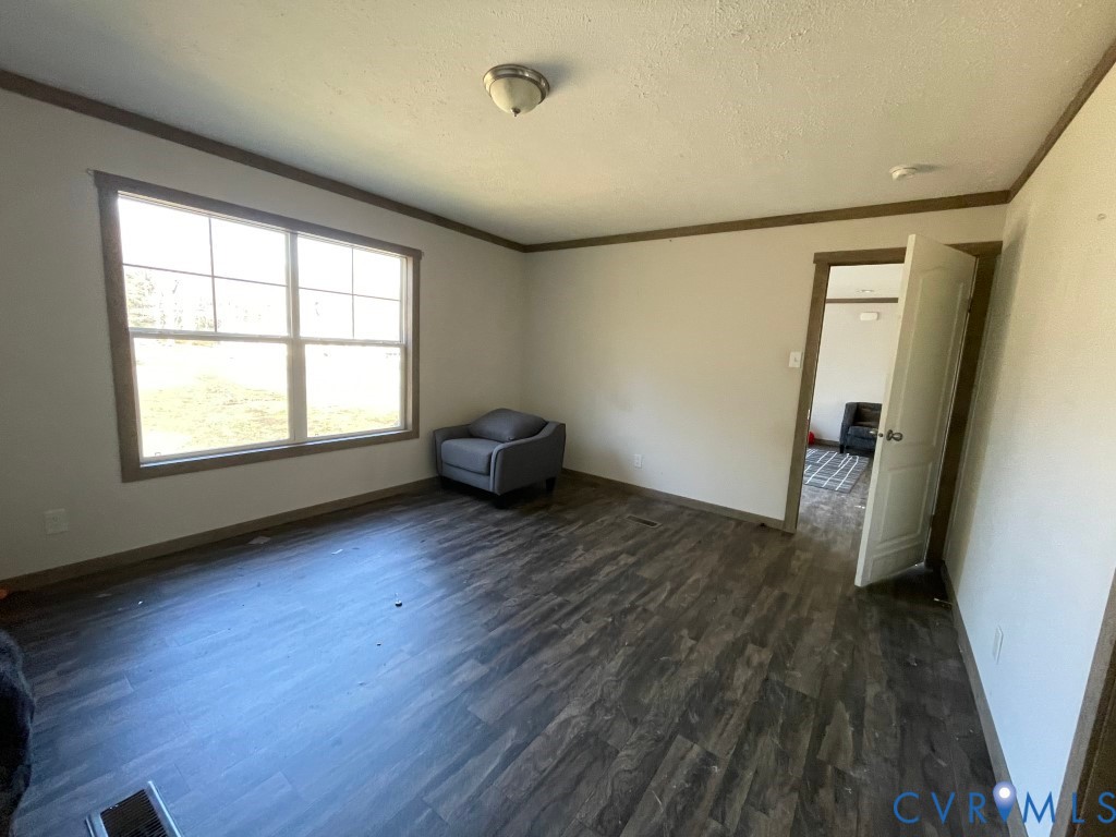 97 Buster Lane West Point, VA 23181 - Photo 25 of 32 an empty room with wooden floor and windows