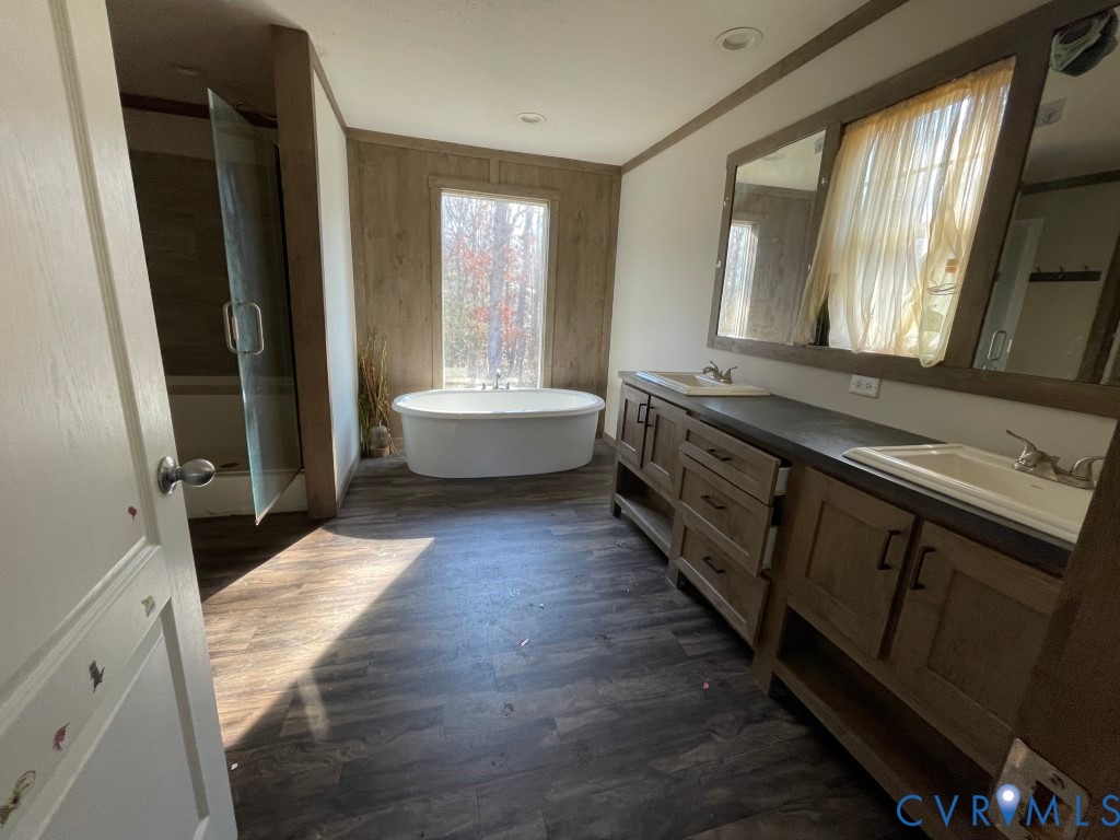 97 Buster Lane West Point, VA 23181 - Photo 26 of 32 a large bathroom with a double vanity sink and a large mirror
