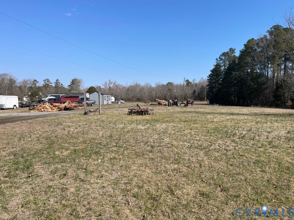 97 Buster Lane West Point, VA 23181 - Photo 30 of 32 a view of a field with an trees in the background