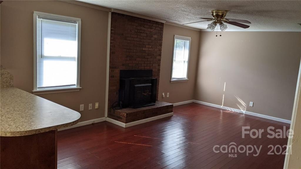 4020 Richardson Road Monroe, NC 28112 - Photo 4 of 18 an empty room with windows and fireplace