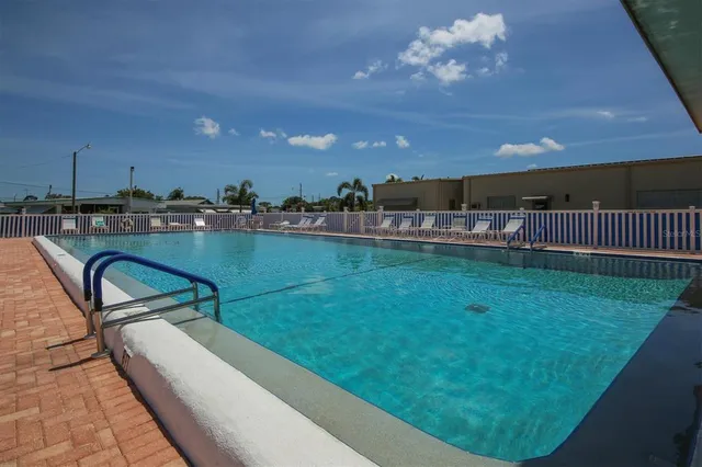 a view of a swimming pool and lounge chairs
