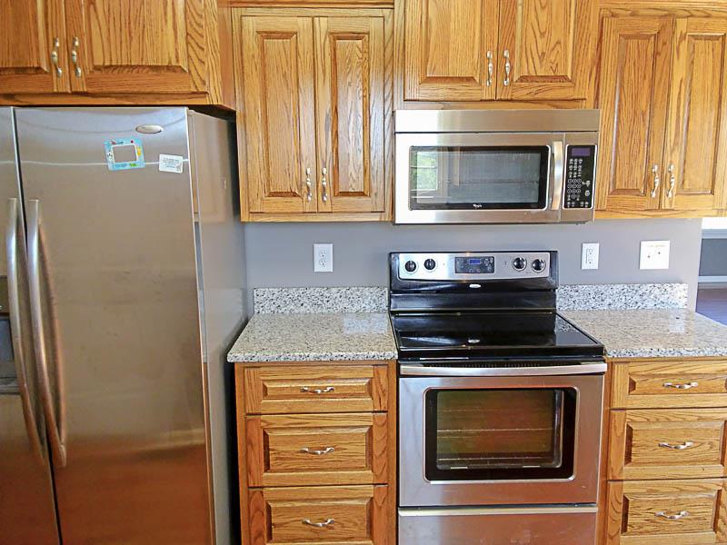 1535 Heller Ridge Spring Hill, TN 37174 - Photo 8 of 23 a kitchen with stainless steel appliances wooden cabinets and a stove top oven
