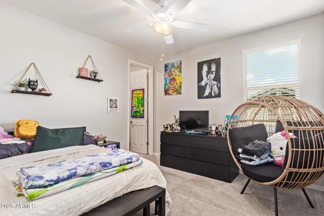 a bedroom with a bed and a chandelier