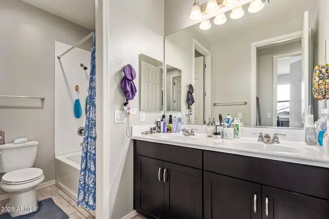 a bathroom with a sink vanity mirror and toilet