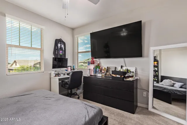 a bedroom with a workspace