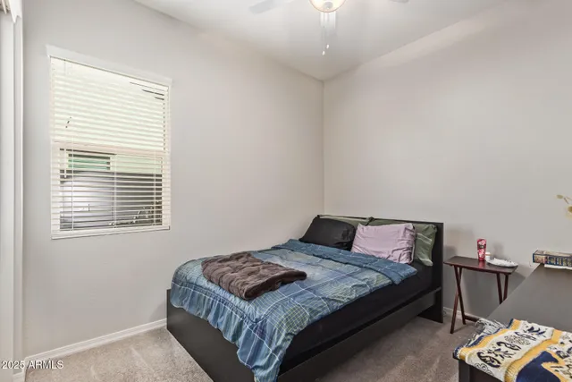 a bedroom with a bed and a table