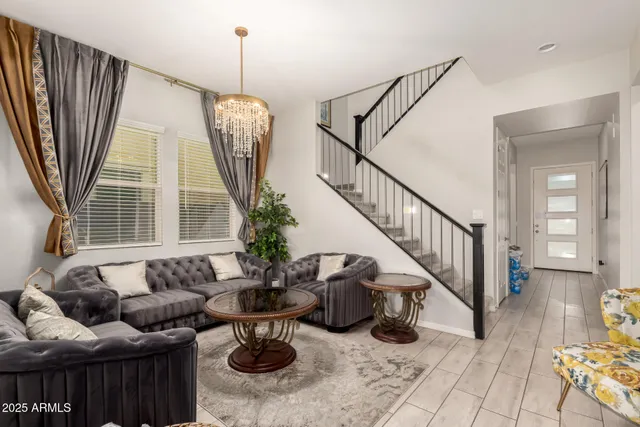 a living room with furniture fireplace and a large window