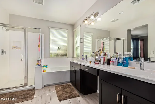 a bathroom with a tub sink and mirror