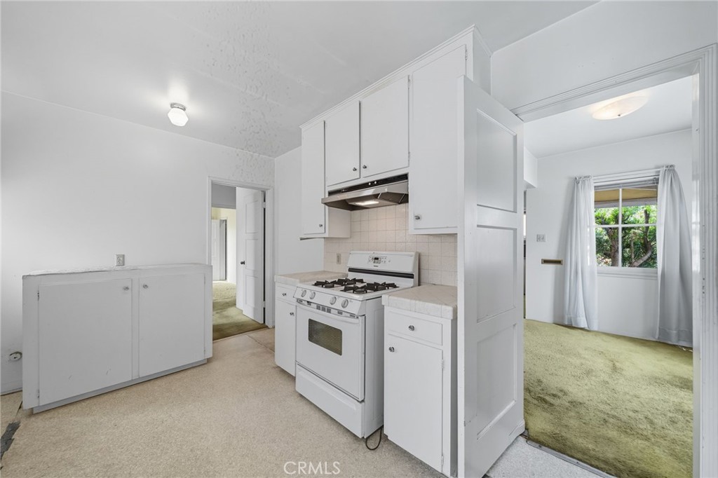978 West Lehigh Street Altadena, CA 91001 - Photo 41 of 49 a kitchen with cabinets a stove and a refrigerator