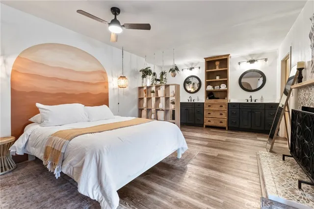 a bedroom with bed and wooden floor