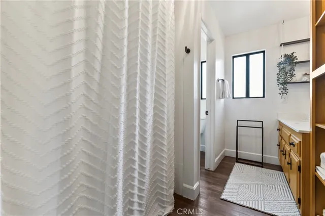 a hallway with white cabinets