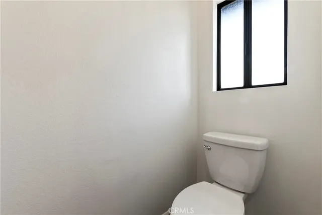 a bedroom with bed and window