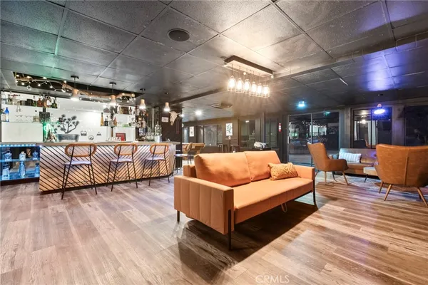a room with lots of wooden furniture and a chandelier