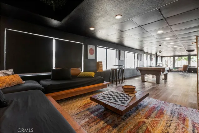 a view of a swimming pool with lounge chairs in patio