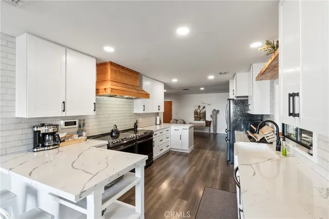 a kitchen with a sink a stove and cabinets
