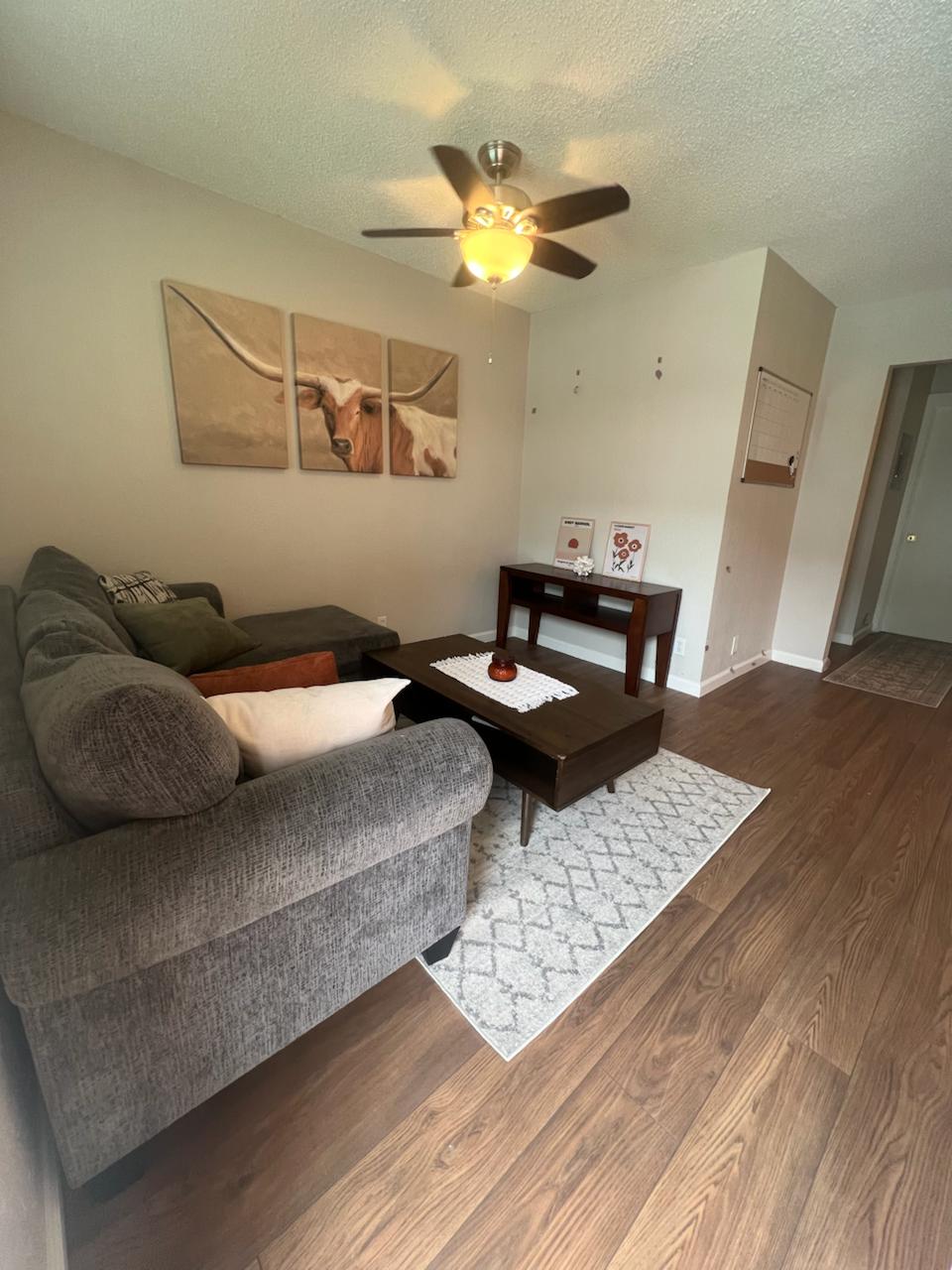 2401 Manor St Road, Unit 118 Austin, TX 78722 - Photo 7 of 17 a living room with furniture and a wooden floor
