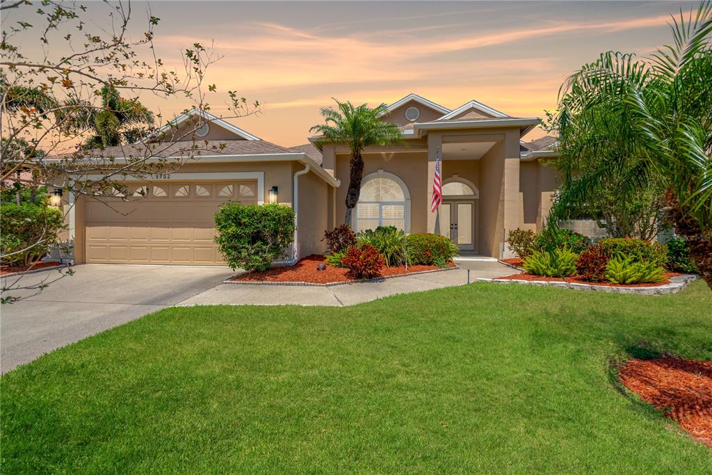 a front view of a house with a garden and plants