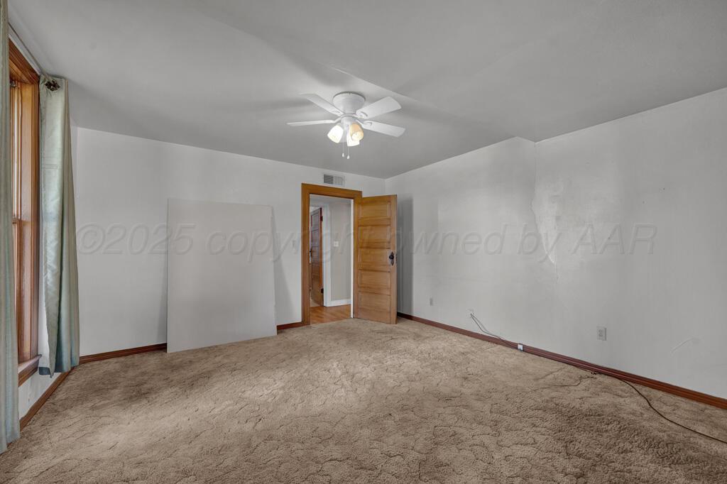 404 Chester Avenue Panhandle, TX 79068 - Photo 13 of 33 a view of an empty room and a ceiling fan window