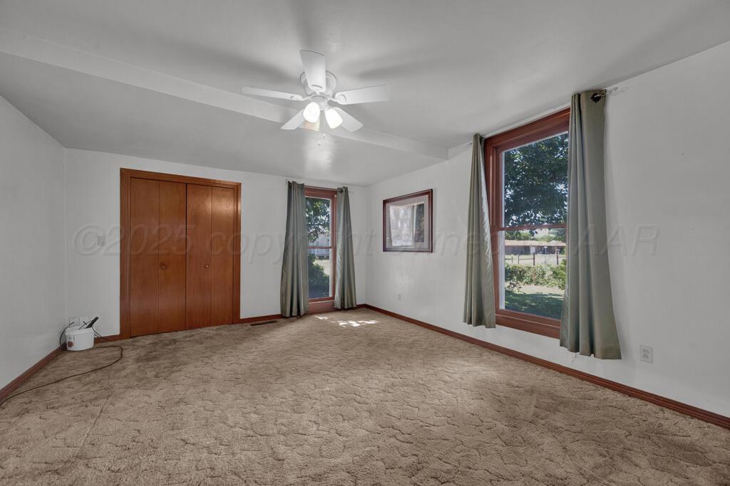 404 Chester Avenue Panhandle, TX 79068 - Photo 14 of 33 a view of a big room with windows and chandelier fan