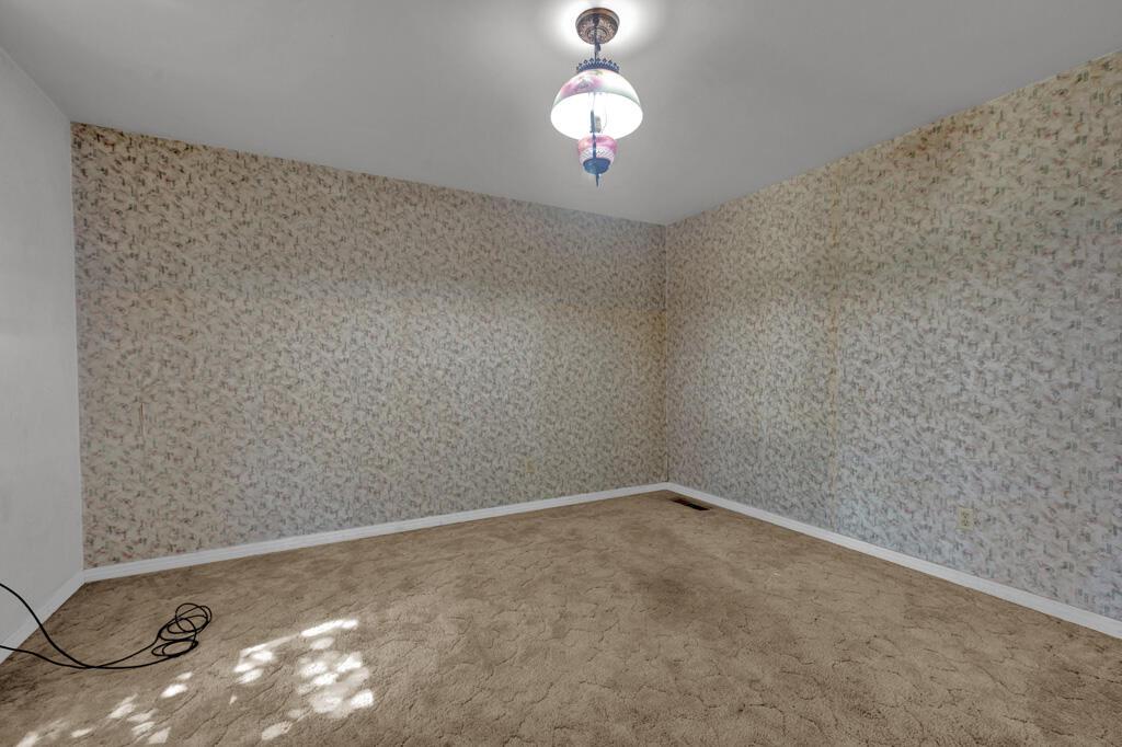 404 Chester Avenue Panhandle, TX 79068 - Photo 19 of 33 a view of a room with wooden floor and fan