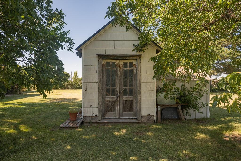 404 Chester Avenue Panhandle, TX 79068 - Photo 29 of 33 a house with a tree in front of it