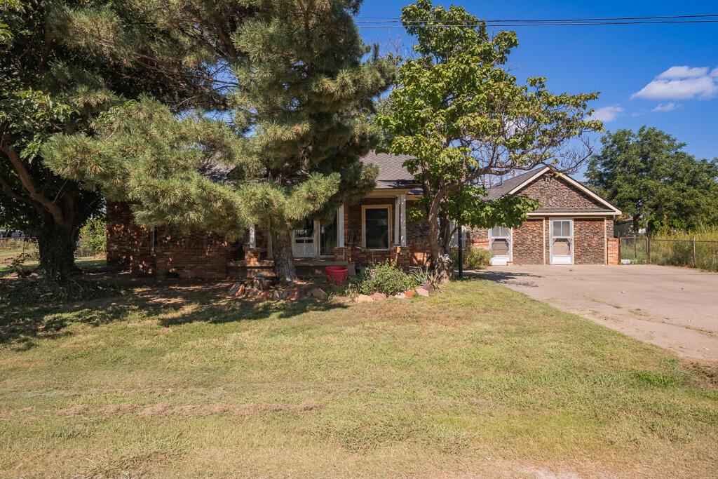 404 Chester Avenue Panhandle, TX 79068 - Photo 3 of 33 a view of a house with backyard and tree
