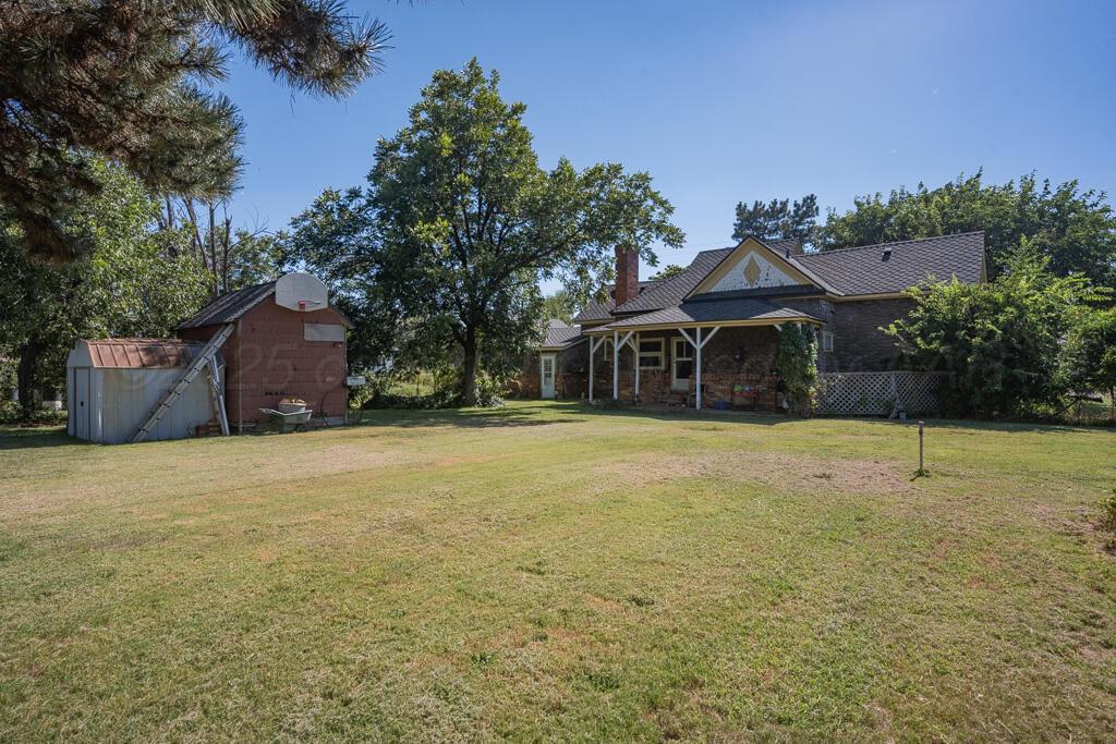 404 Chester Avenue Panhandle, TX 79068 - Photo 32 of 33 a house with trees in front of it