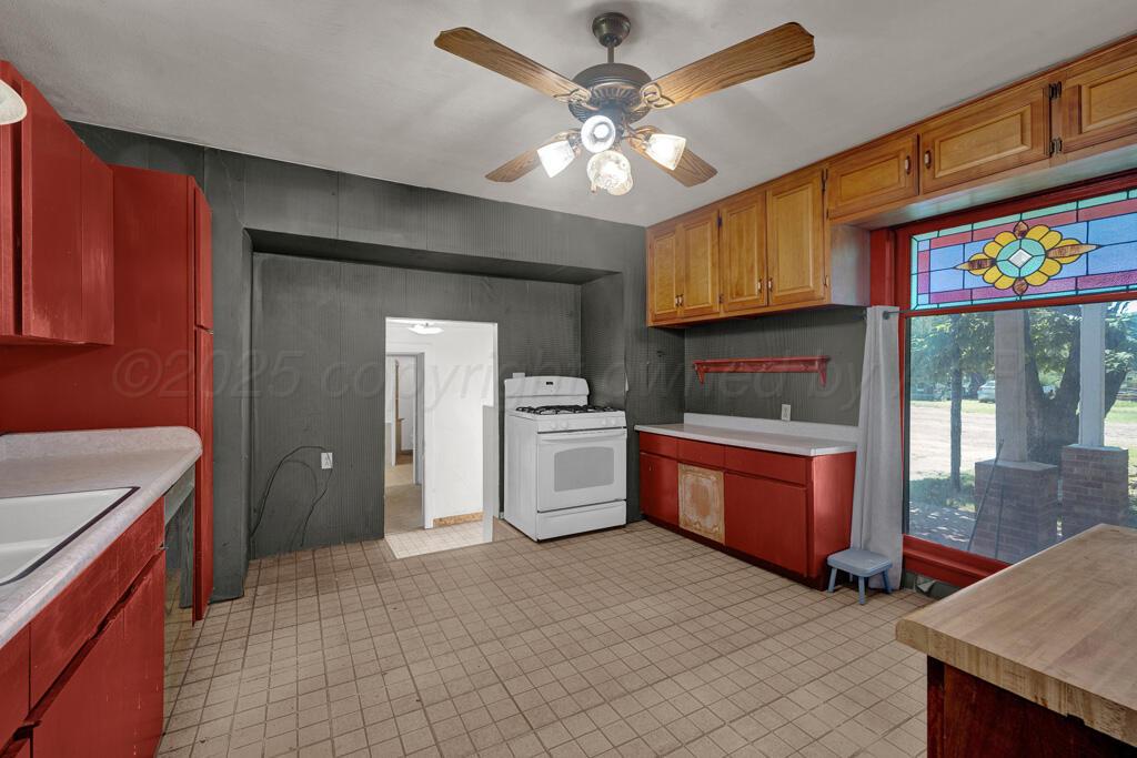 404 Chester Avenue Panhandle, TX 79068 - Photo 9 of 33 a kitchen with stainless steel appliances granite countertop a sink and cabinets
