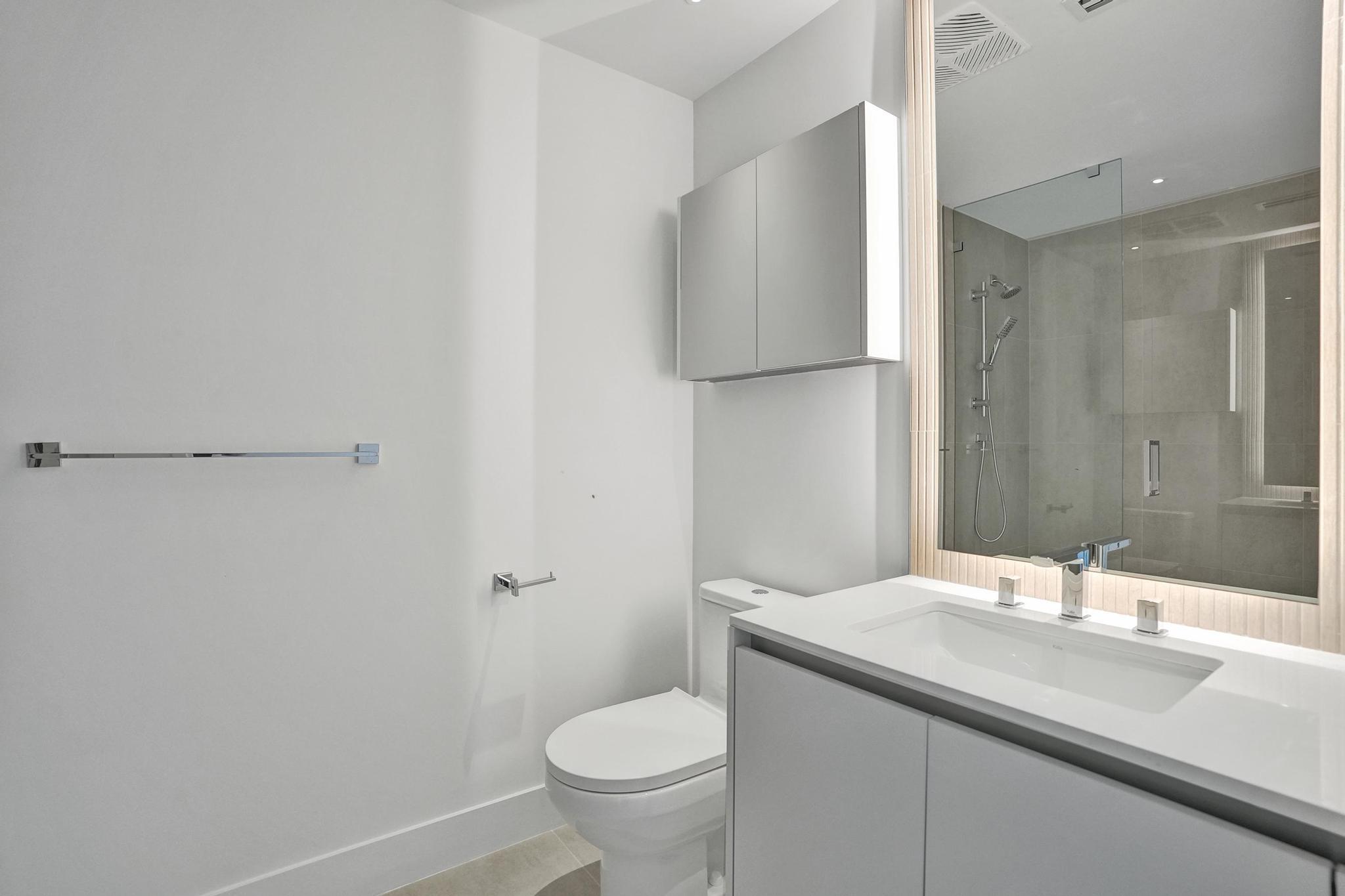 407 North Riverside Drive, Unit 605 Pompano Beach, FL 33062 - Photo 34 of 93 a bathroom with a granite countertop sink toilet and a mirror
