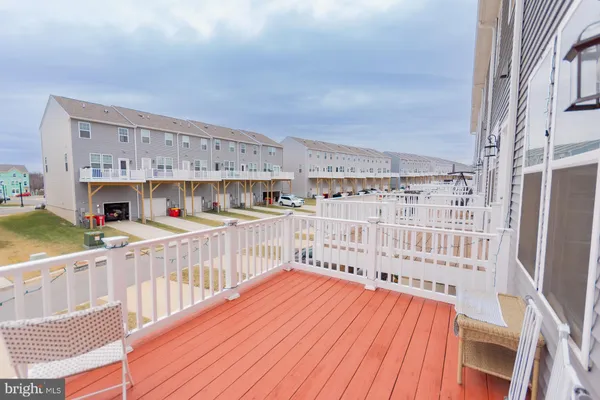 a living room with furniture a wooden floor and white walls