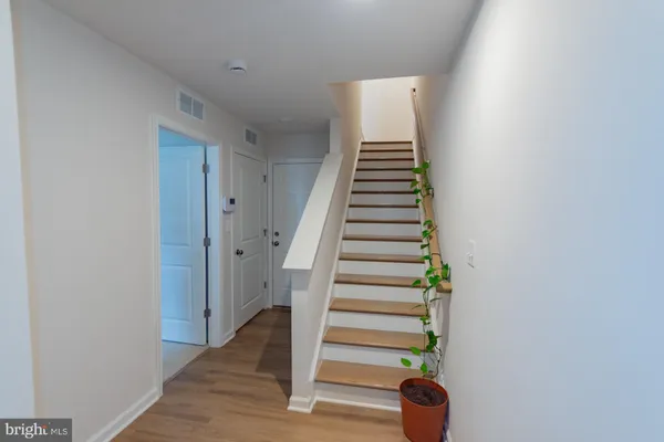 a view of entryway and hall with wooden floor