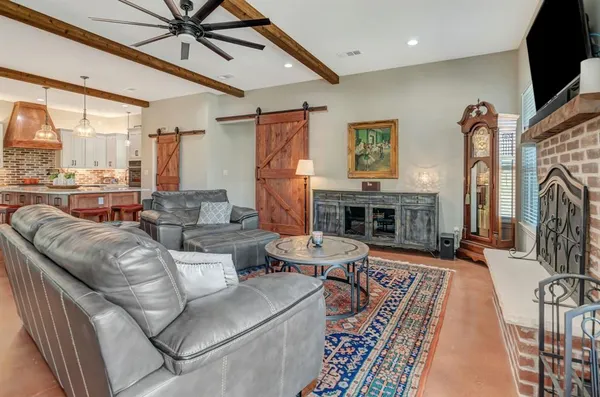 a living room with furniture a large window and a fireplace