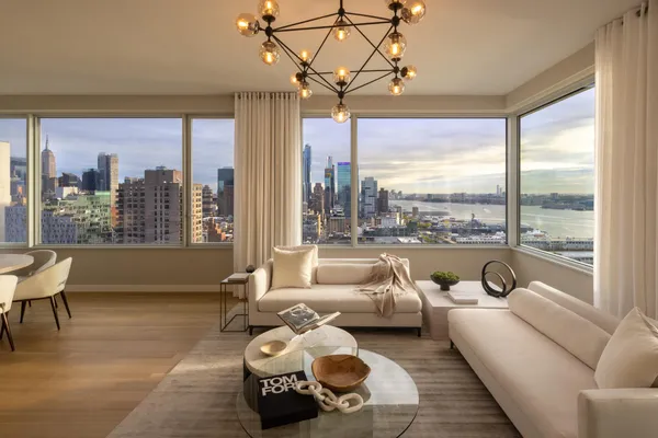 a living room with furniture and large windows