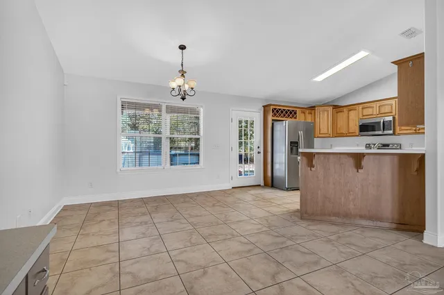 a kitchen with stainless steel appliances granite countertop a stove a sink dishwasher and a refrigerator