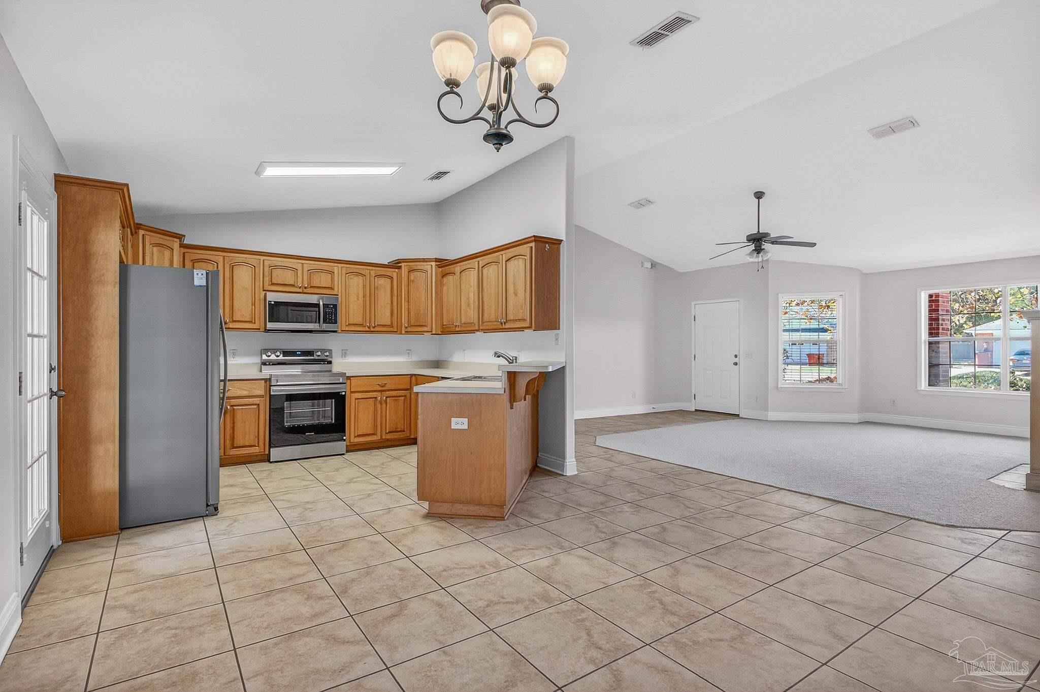 6050 Antelope Street Milton, FL 32570 - Photo 14 of 58 a kitchen with stainless steel appliances granite countertop a stove a sink dishwasher and a refrigerator