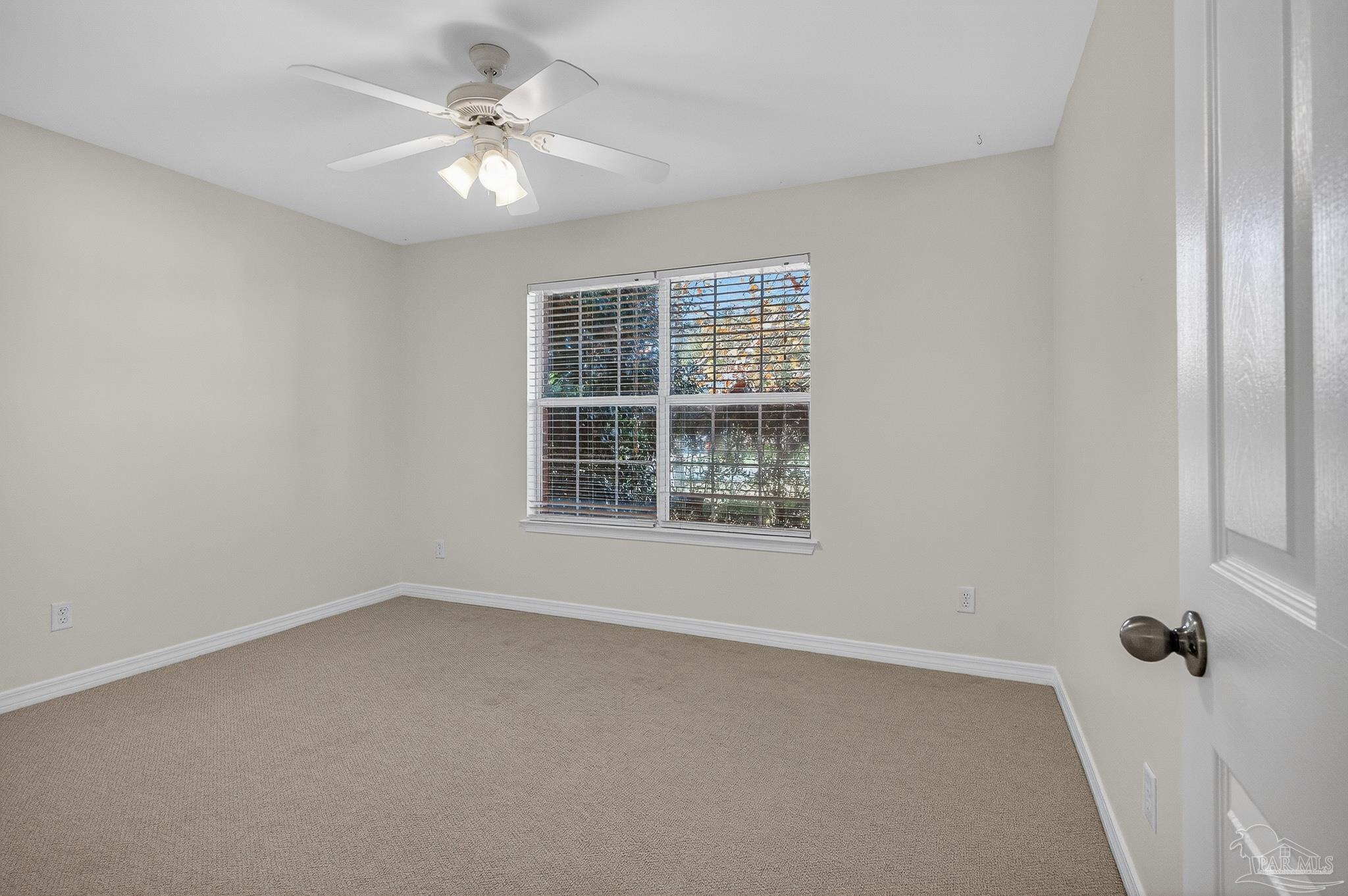 6050 Antelope Street Milton, FL 32570 - Photo 23 of 58 an empty room with windows and fan