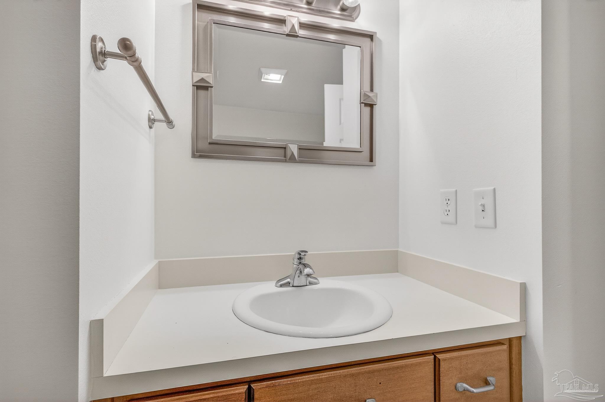 6050 Antelope Street Milton, FL 32570 - Photo 30 of 58 a bathroom with a sink and a mirror