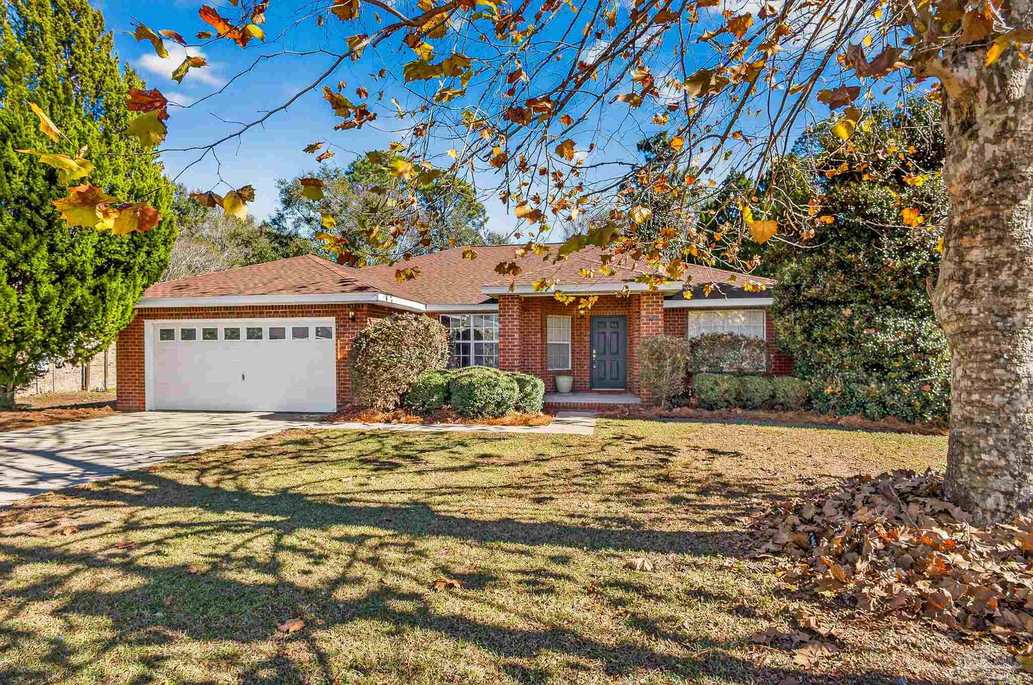 6050 Antelope Street Milton, FL 32570 - Photo 3 of 58 a front view of a house with a garden