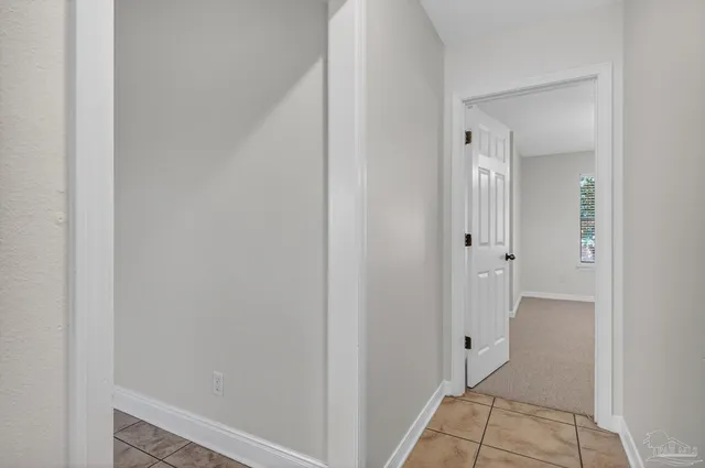 an empty room with a ceiling fan and a window