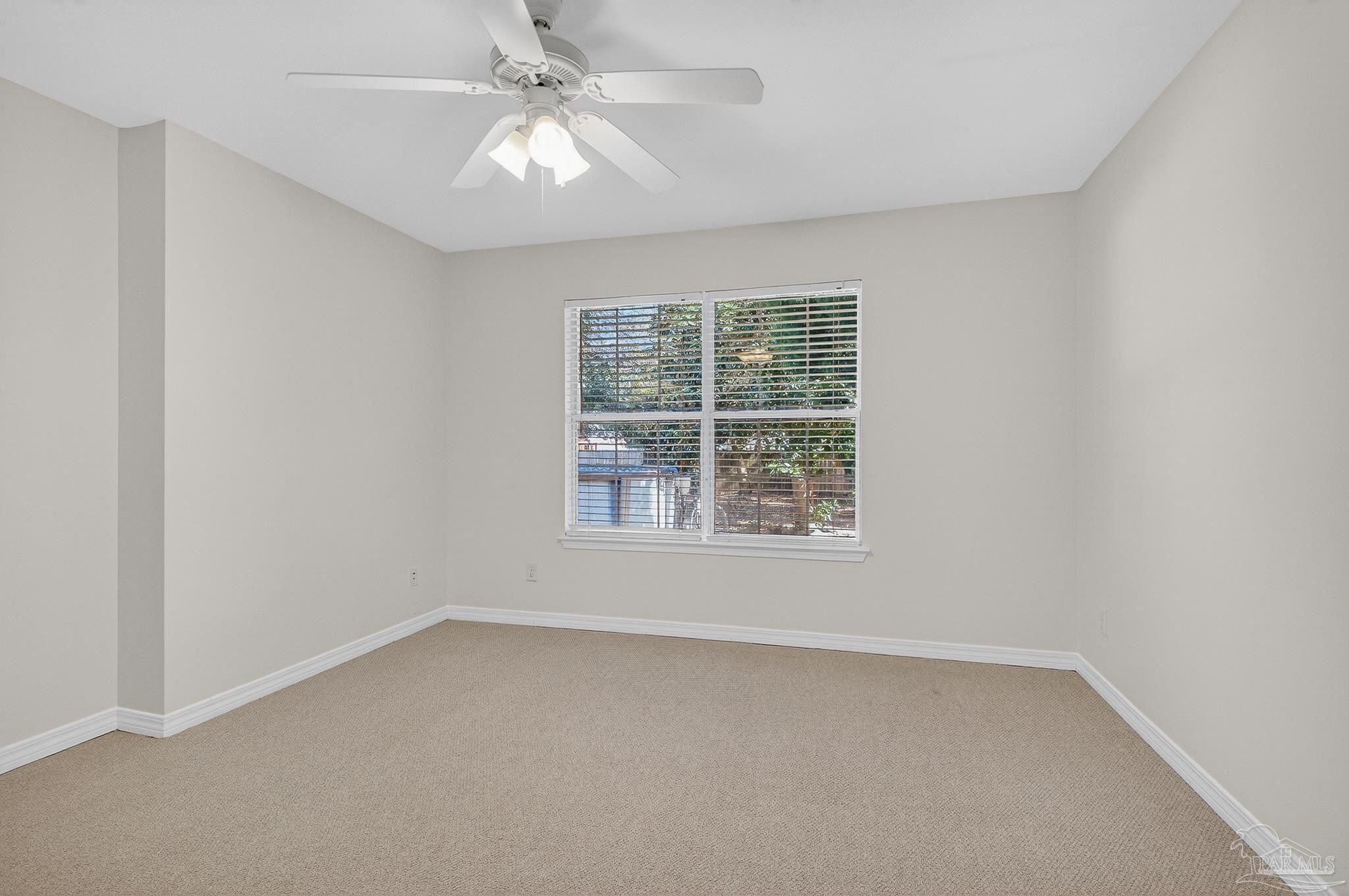 6050 Antelope Street Milton, FL 32570 - Photo 34 of 58 an empty room with a window and a fan