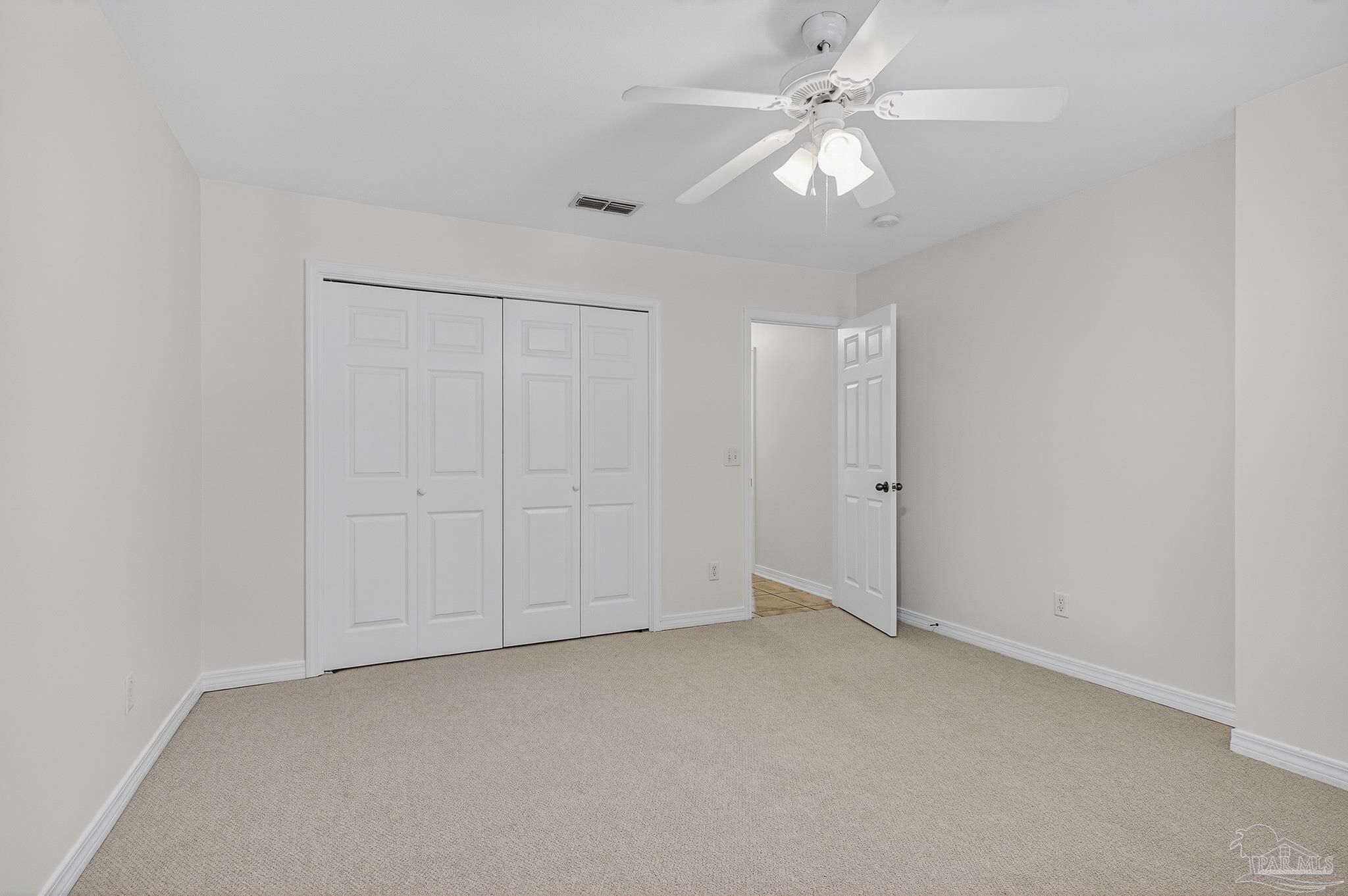 6050 Antelope Street Milton, FL 32570 - Photo 35 of 58 an empty room with a ceiling fan and a window