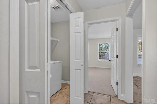 an empty room with closet and windows